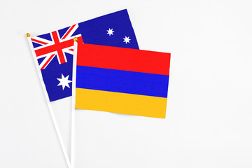 Armenia and Australia stick flags on white background. High quality fabric, miniature national flag. Peaceful global concept.White floor for copy space.