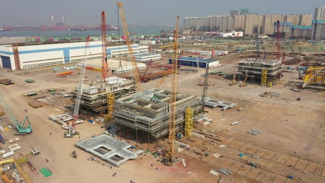 Aerial view of construction site for petrochemical drilling platforms in Port of Qingdao, used for offshore exploration activities in South China Sea and elsewhere
