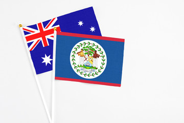 Fototapeta premium Belize and Australia stick flags on white background. High quality fabric, miniature national flag. Peaceful global concept.White floor for copy space.