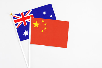 China and Australia stick flags on white background. High quality fabric, miniature national flag. Peaceful global concept.White floor for copy space.