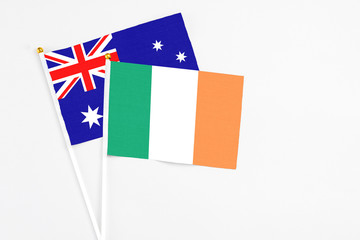 Ireland and Australia stick flags on white background. High quality fabric, miniature national flag. Peaceful global concept.White floor for copy space.