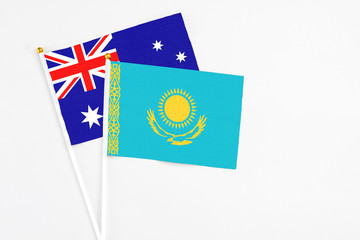 Kazakhstan and Australia stick flags on white background. High quality fabric, miniature national flag. Peaceful global concept.White floor for copy space.