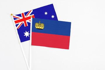 Liechtenstein and Australia stick flags on white background. High quality fabric, miniature national flag. Peaceful global concept.White floor for copy space.
