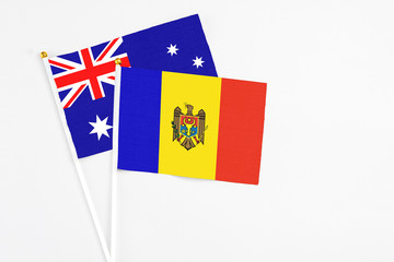 Moldova and Australia stick flags on white background. High quality fabric, miniature national flag. Peaceful global concept.White floor for copy space.