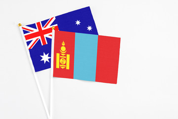 Mongolia and Australia stick flags on white background. High quality fabric, miniature national flag. Peaceful global concept.White floor for copy space.