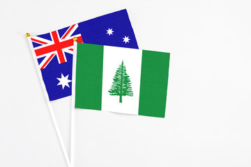 Norfolk Island and Australia stick flags on white background. High quality fabric, miniature national flag. Peaceful global concept.White floor for copy space.