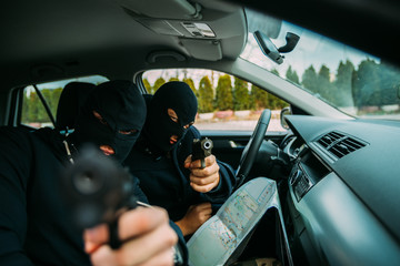 Gangster pointing with their guns at the camera.