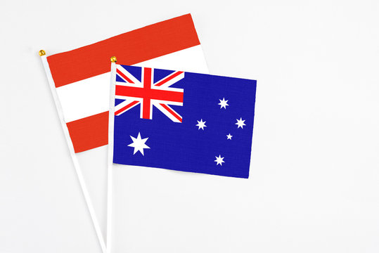 Australia and Austria stick flags on white background. High quality fabric, miniature national flag. Peaceful global concept.White floor for copy space.