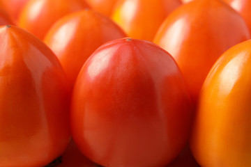 Persimmon close-up. Natural orange background.