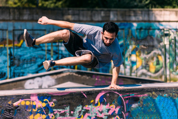 Parkour man training jumping over obstacles