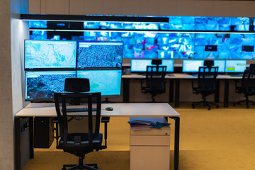 Empty office, desk, and chairs at a main CCTV security data center.