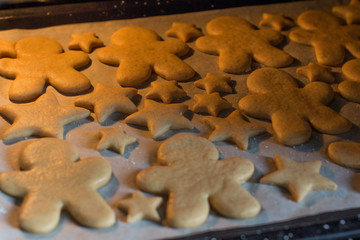 making christmas gingerbread cookies in a kitchen oven