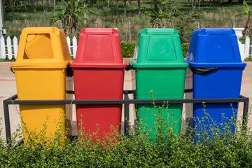 Multicolours recycle bin setting at the public park. A container used to hold recyclables before...