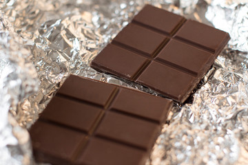 a bar of a dark chocolate in a silver wrap 