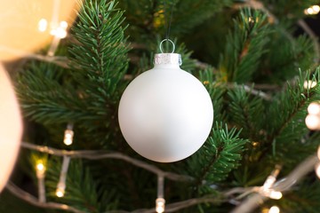 white christmas ornaments and lights on christmas tree