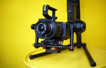 camera with equipment on yellow background