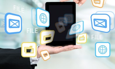 Hands holding digital tablet with illustration icons