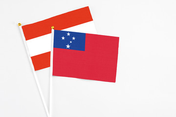 Samoa and Austria stick flags on white background. High quality fabric, miniature national flag. Peaceful global concept.White floor for copy space.
