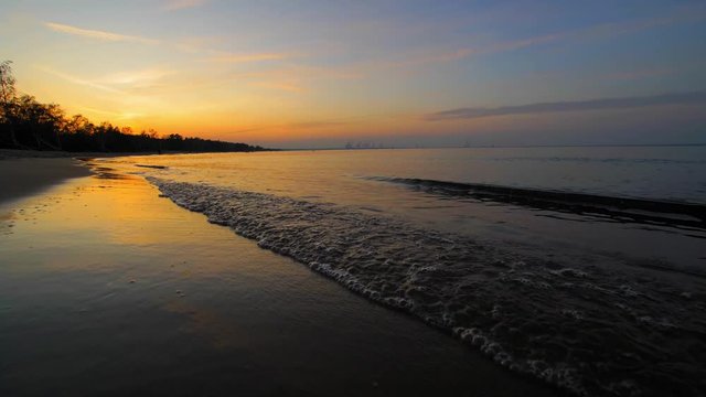 Peaceful Landscape of Calm Sea Waves on Sandy Beach after Sunset