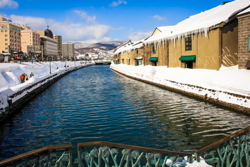 Beautiful scenery of Otaru wearhouses along the Otaru canal in winter with blue sky in background