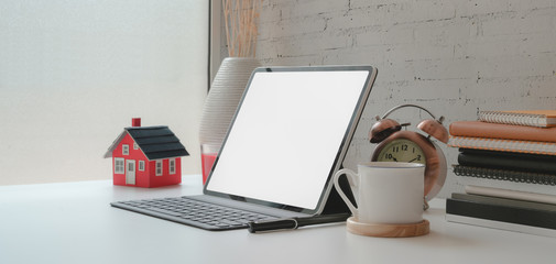 Contemporary workplace with blank screen digital tablet and office supplies