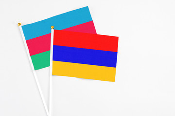 Armenia and Azerbaijan stick flags on white background. High quality fabric, miniature national flag. Peaceful global concept.White floor for copy space.