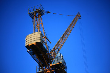Fototapeta na wymiar A yellow crane with a blue sky