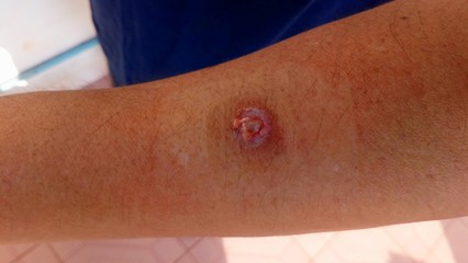 closeup of a woman measuring her belly