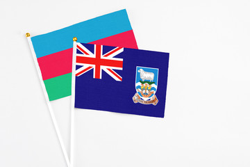 Falkland Islands and Azerbaijan stick flags on white background. High quality fabric, miniature national flag. Peaceful global concept.White floor for copy space.