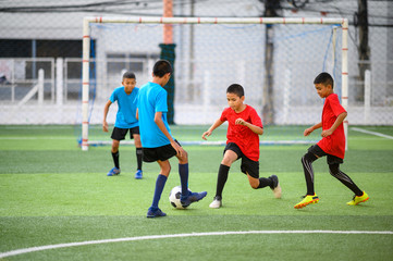Boys playing football on the football practice field