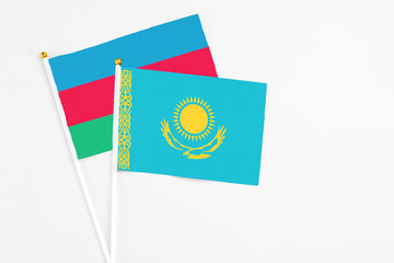 Kazakhstan and Azerbaijan stick flags on white background. High quality fabric, miniature national flag. Peaceful global concept.White floor for copy space.