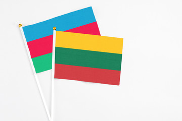 Lithuania and Azerbaijan stick flags on white background. High quality fabric, miniature national flag. Peaceful global concept.White floor for copy space.