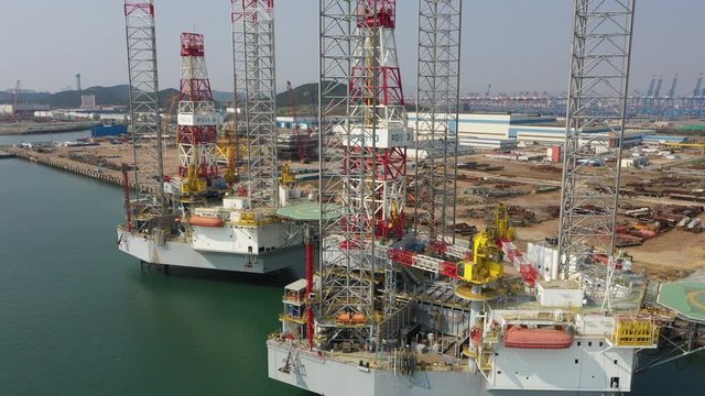 Ascending drone shot of new offshore oil drilling platforms in Qingdao, China