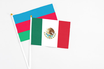 Mexico and Azerbaijan stick flags on white background. High quality fabric, miniature national flag. Peaceful global concept.White floor for copy space.