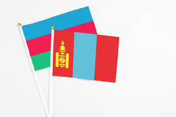 Naklejka premium Mongolia and Azerbaijan stick flags on white background. High quality fabric, miniature national flag. Peaceful global concept.White floor for copy space.