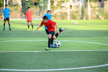 Boys playing football on the football practice field