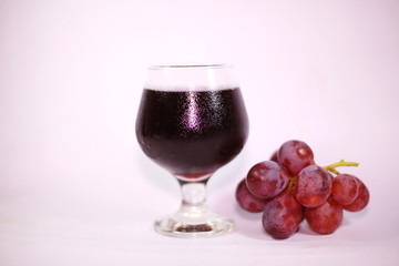 Purple grape juice on a white background