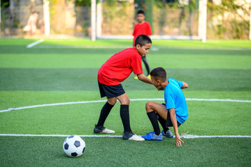 Boys playing football on the football practice field