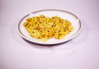 Fried peas on a plate, white background