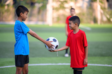 Boys playing football on the football practice field