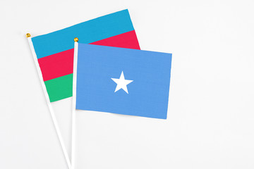 Somalia and Azerbaijan stick flags on white background. High quality fabric, miniature national flag. Peaceful global concept.White floor for copy space.