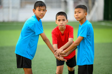 Boys playing football on the football practice field