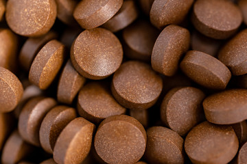 Brown iron supplement pills in the hands