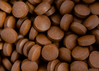 Brown iron supplement pills in the hands