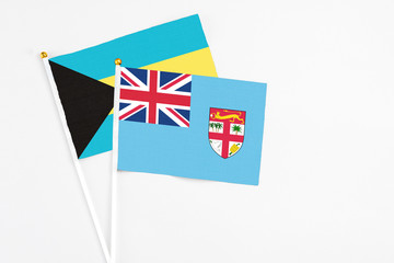 Fiji and Bahamas stick flags on white background. High quality fabric, miniature national flag....