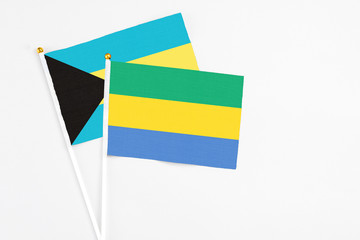 Gabon and Bahamas stick flags on white background. High quality fabric, miniature national flag....