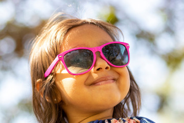 Cute little girl with pink sunglasses