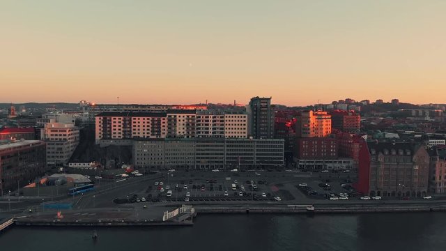 Aerial over waterfront area of Gothenburg in late light. Drone slow forward dolly