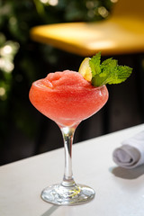 Fresh alcohol cocktail or lemonade beverage outside of restaurant in a summer day