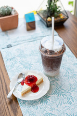 ice coffee take away and cake on wooden background
